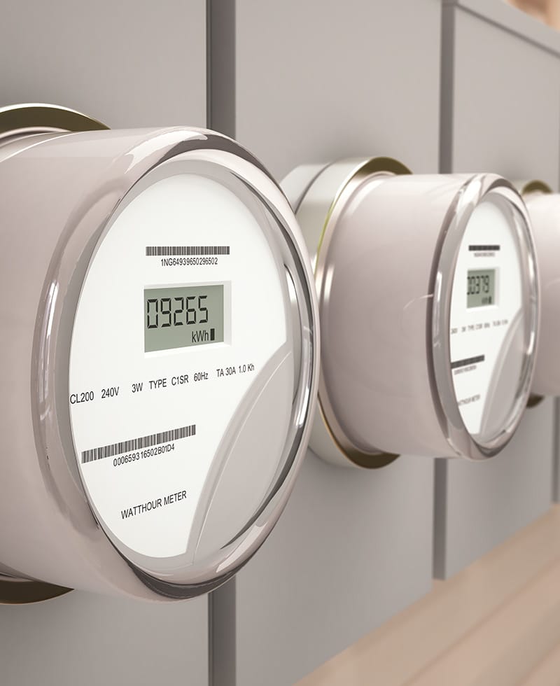Close-up of digital electricity smart meters on a wall.